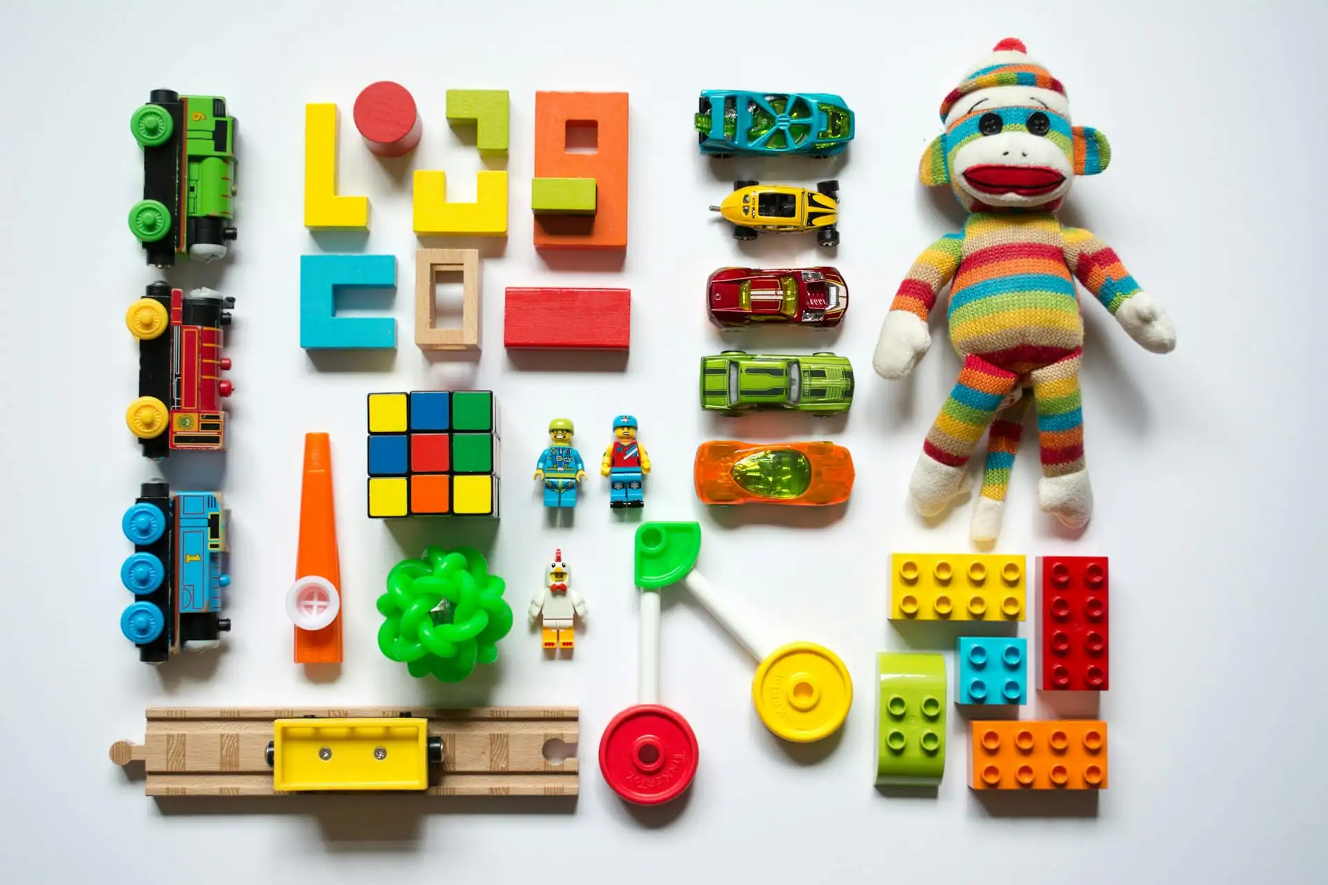 Toddler’s hands playing with colourful wooden toys