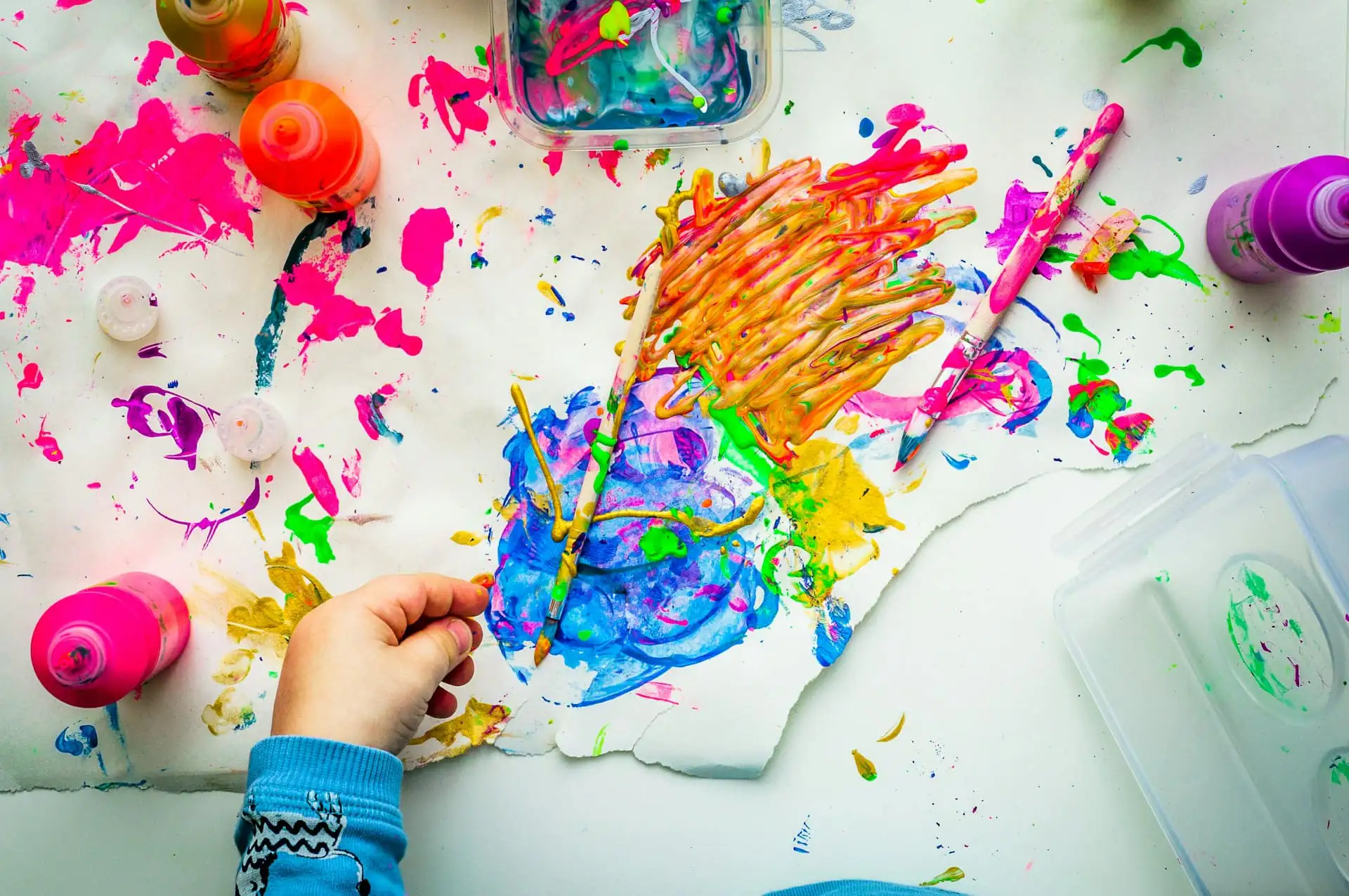 Colourful children’s paintings laid out to dry